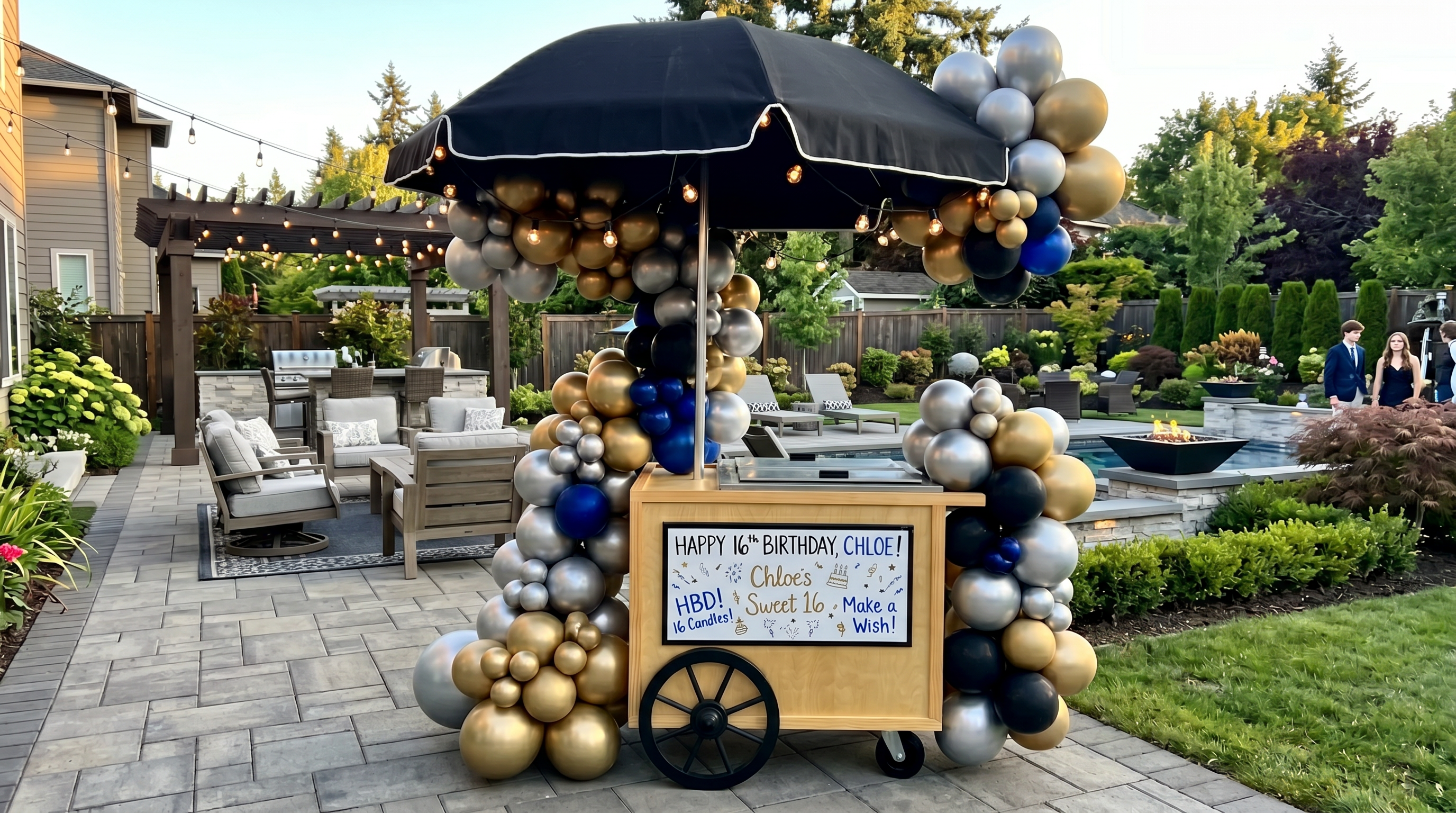 Wide birthday party cart setup with balloon garland